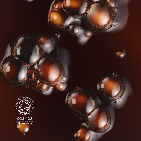 Close up of sun drops texture, the liquid has a rich, deep color. The image also features the